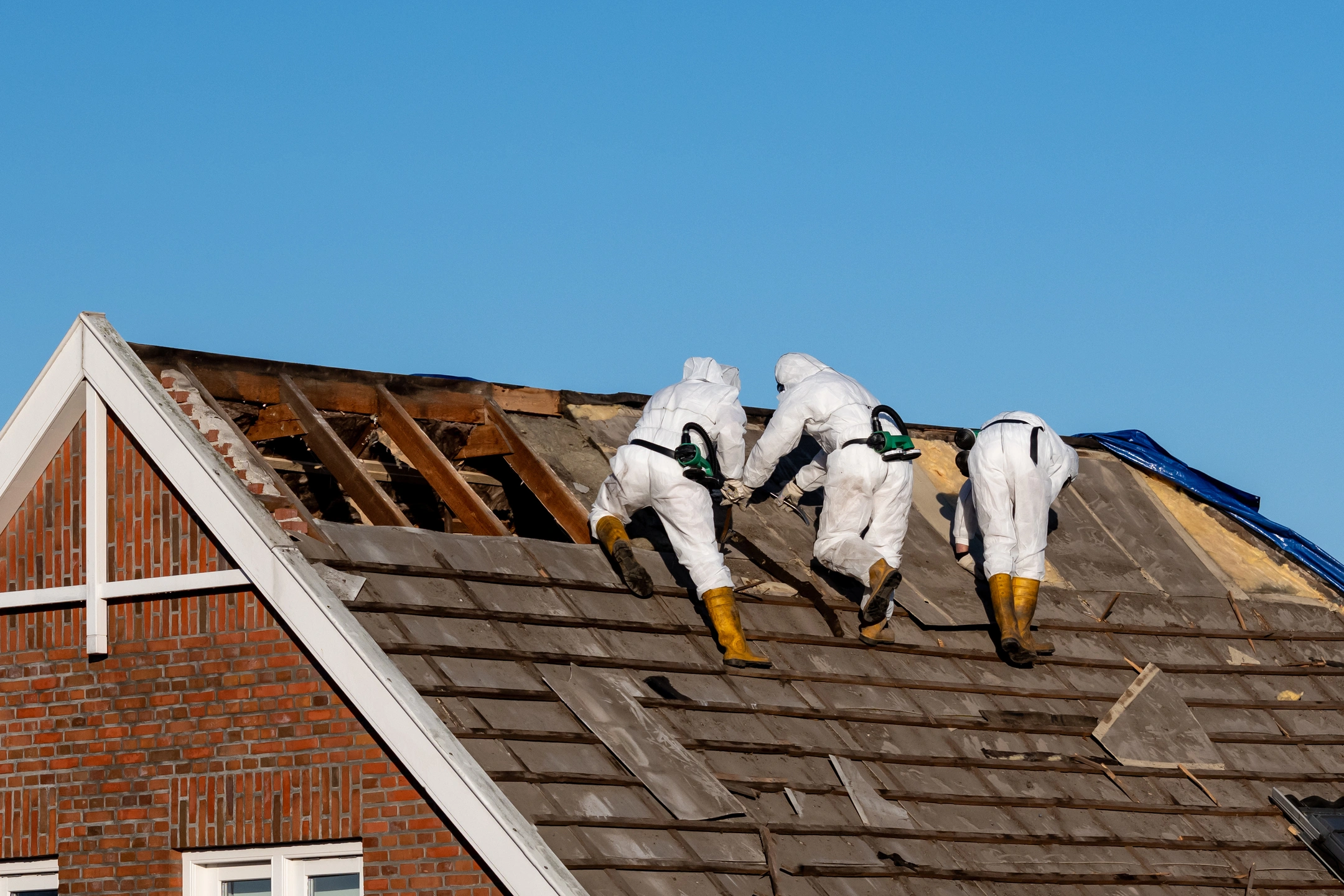workers removing asbestos shingles