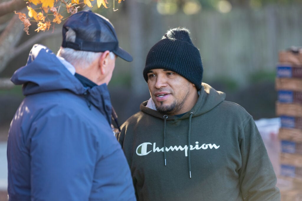 two men talking outside