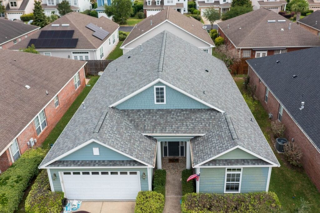 Blue house with grey shingle roof