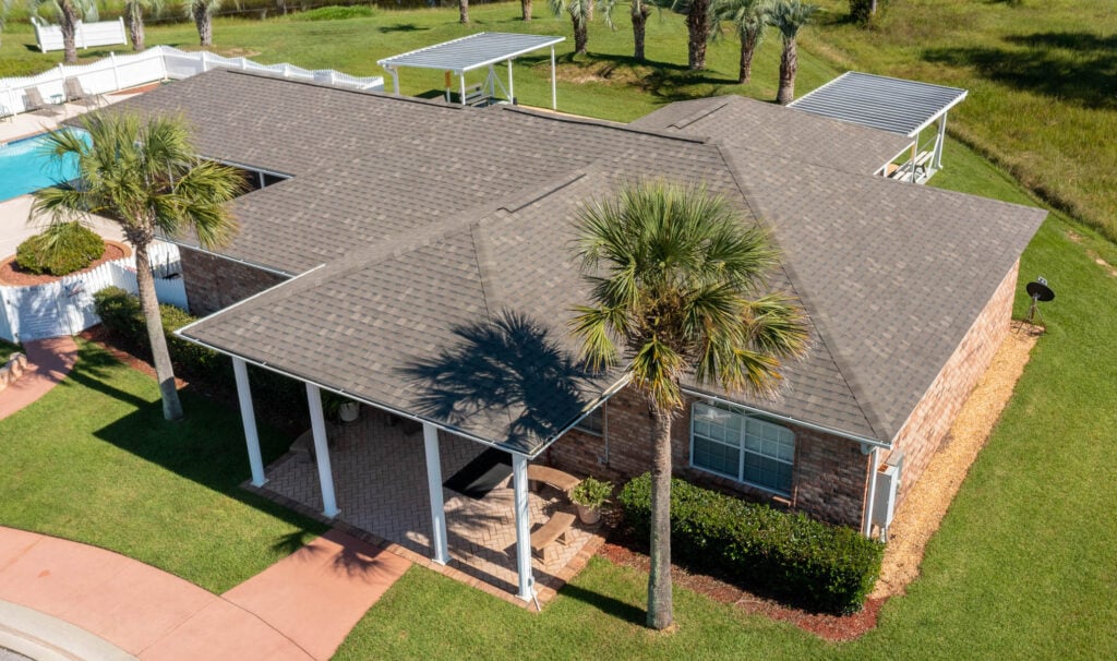 house with shingle roof and palm trees