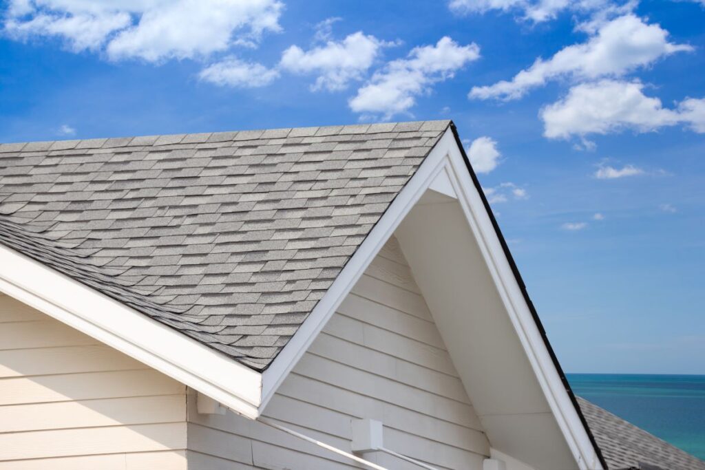 grey shingle roof with blue sky