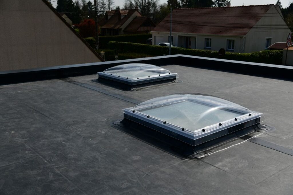 EPDM vs TPO black roof surrounded by house windows