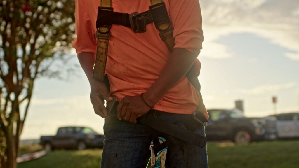 How to tarp a roof Quality Roofing Solution worker with uniform