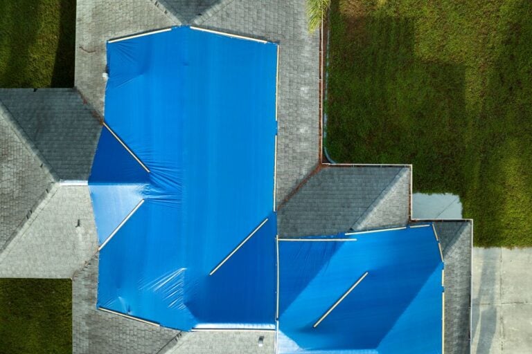How to tarp a roof aerial view house blue cover charcoal shingles