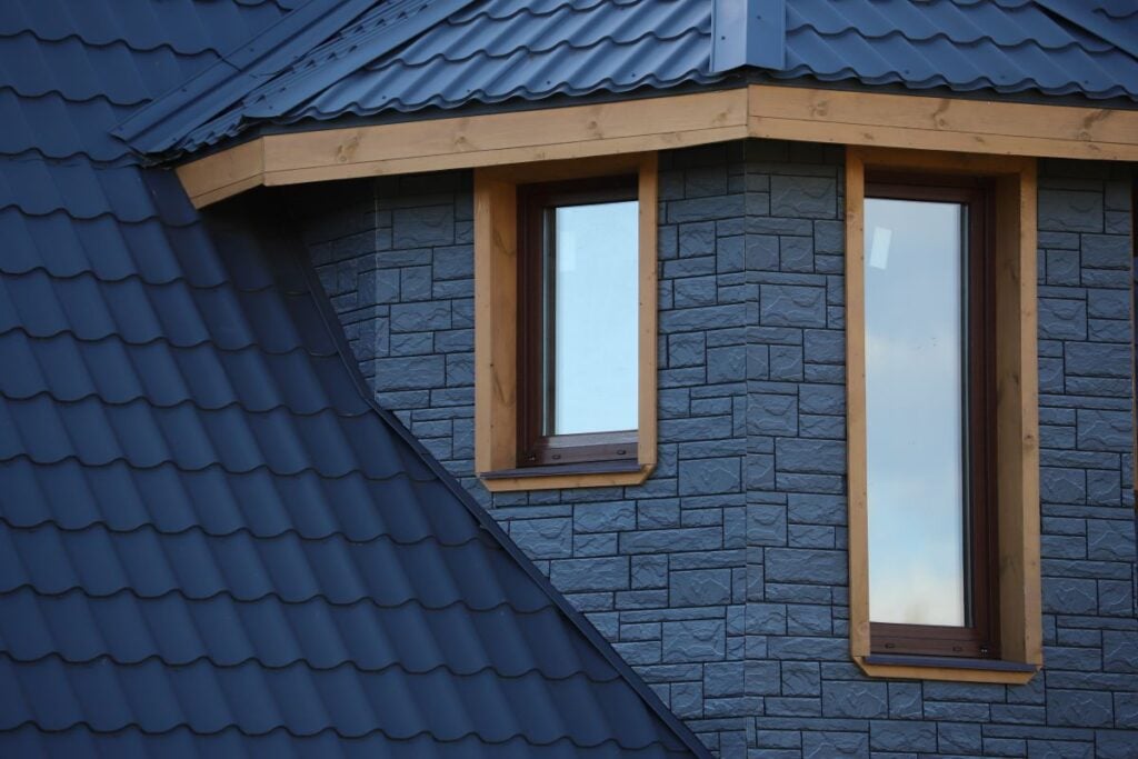 Metal roof vs tile roof dark blue modern roof
