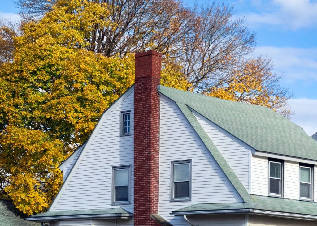green gambrel roof white siding white windows