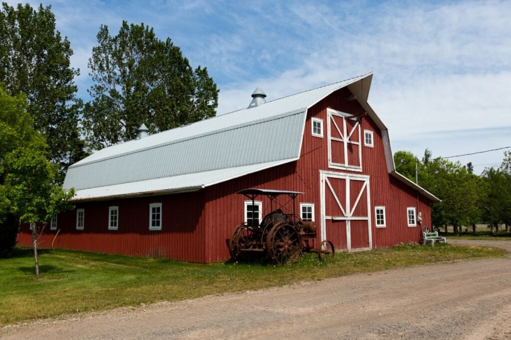 white gambrel roof red siding farm