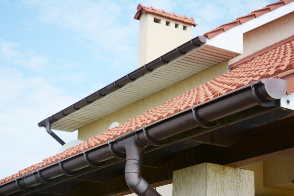 Plastic guard over gutter failure on a roof with a leaves stuck under the mesh