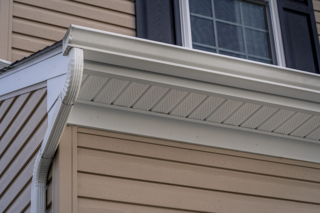 Gable with vinyl siding, white frame gutter guard system