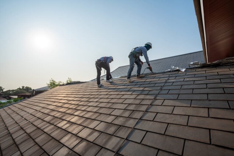 Roofer working in special protective work wear gloves