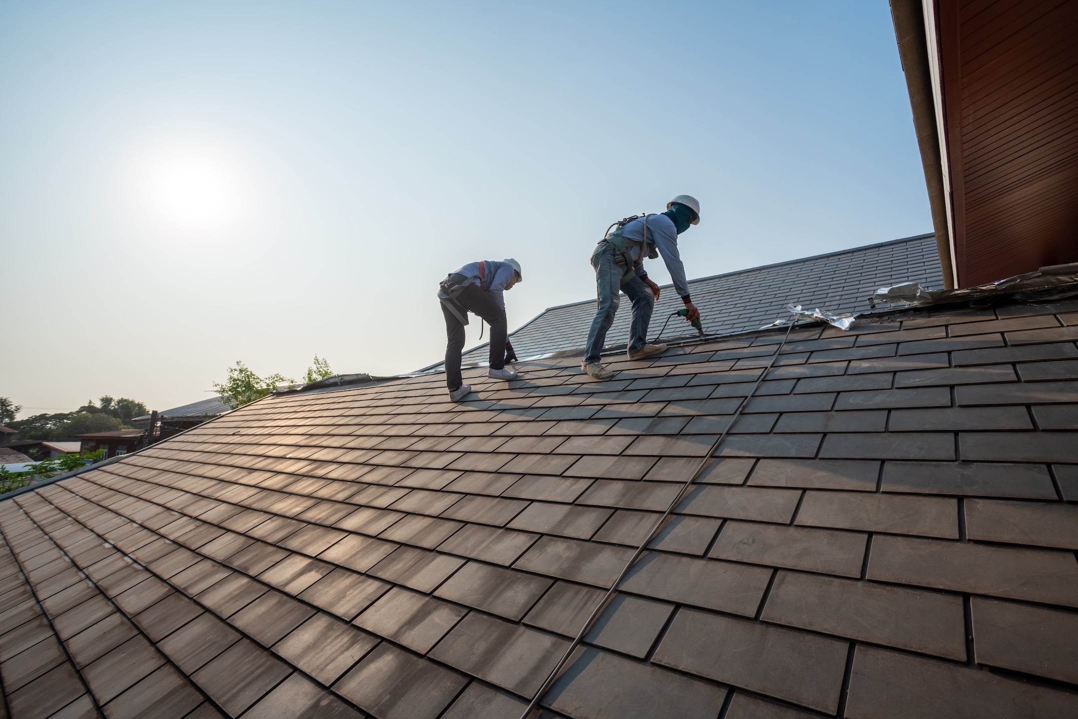 Roofer working in special protective work wear gloves