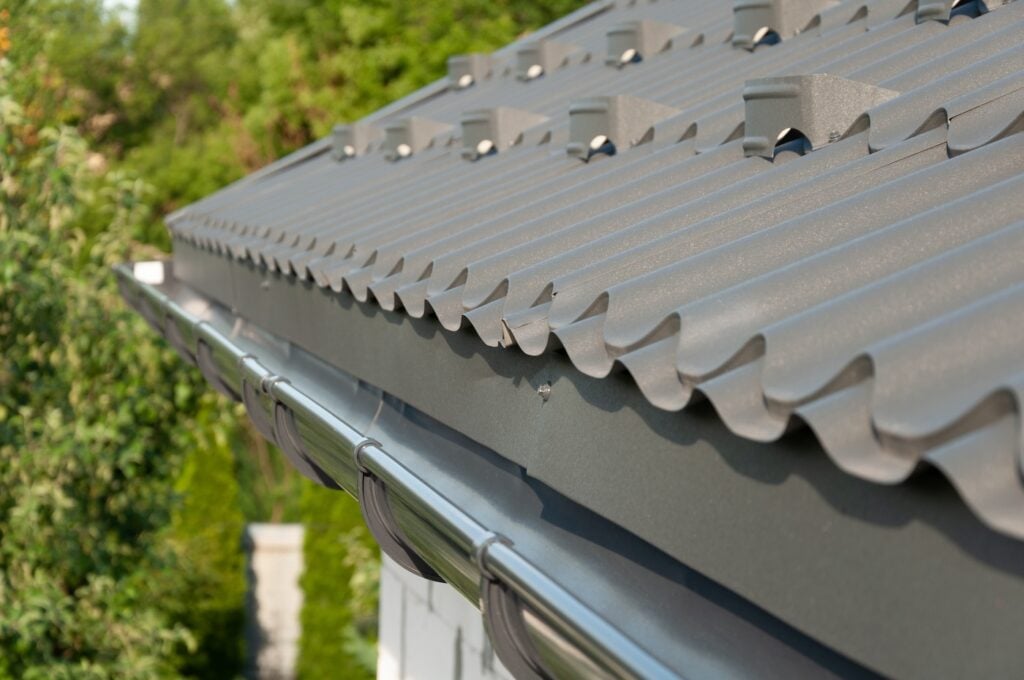 Gray metal roof tiles and rain gutter