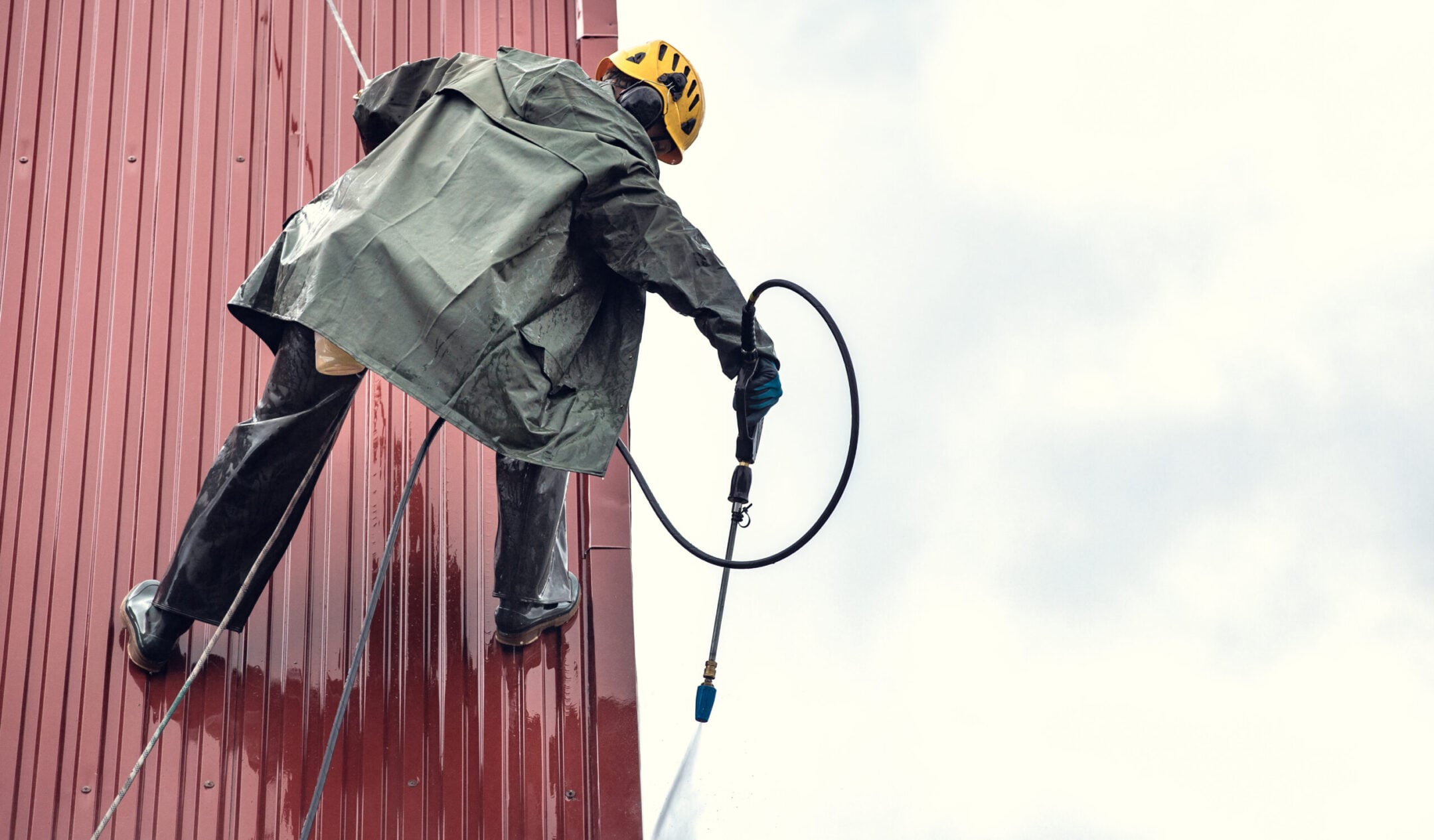 Washing the roof with a high-pressure washer.