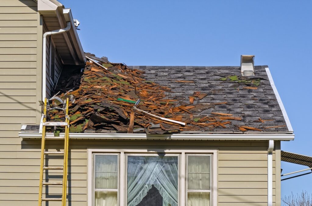 Old Roofing Being Removed on House to be Replaced by New Shingles