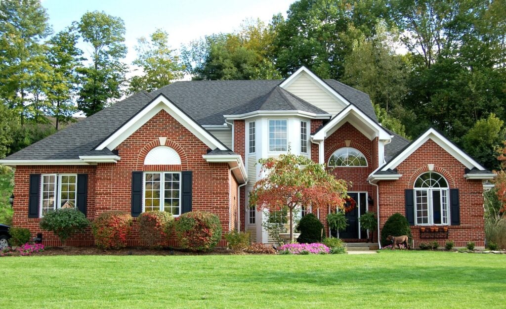 brick house dark gray roofing