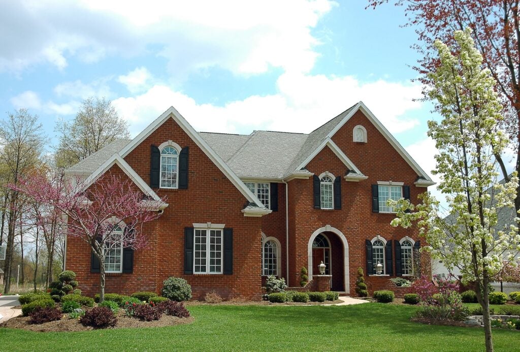 red brick home and new asphalt shingle installation