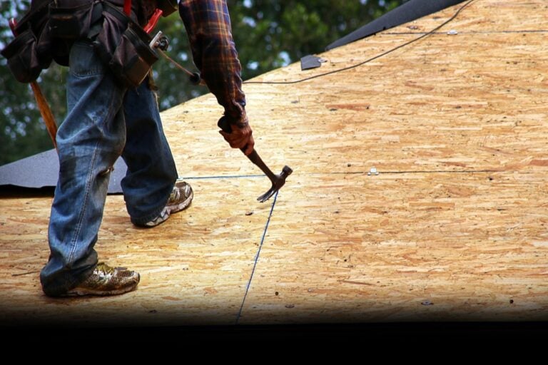 Roofer Removing Old Nails from Roof Deck