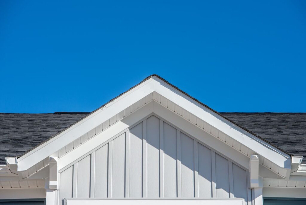Detailed view of a gable-style dormer window on a sloped roof of a newly built family house