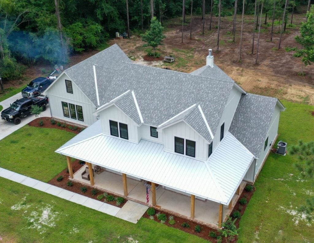 A large house with shingle and metal roof