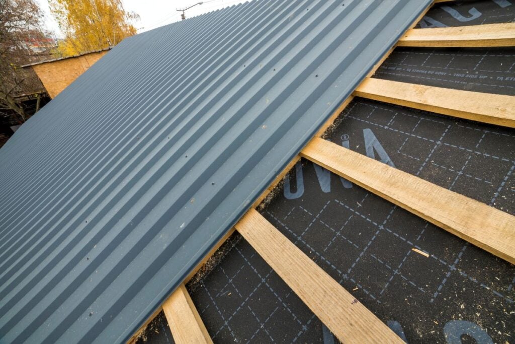 metal roof being installed on top of underlayment