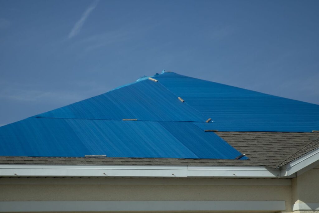 roof covered in a blue tarp