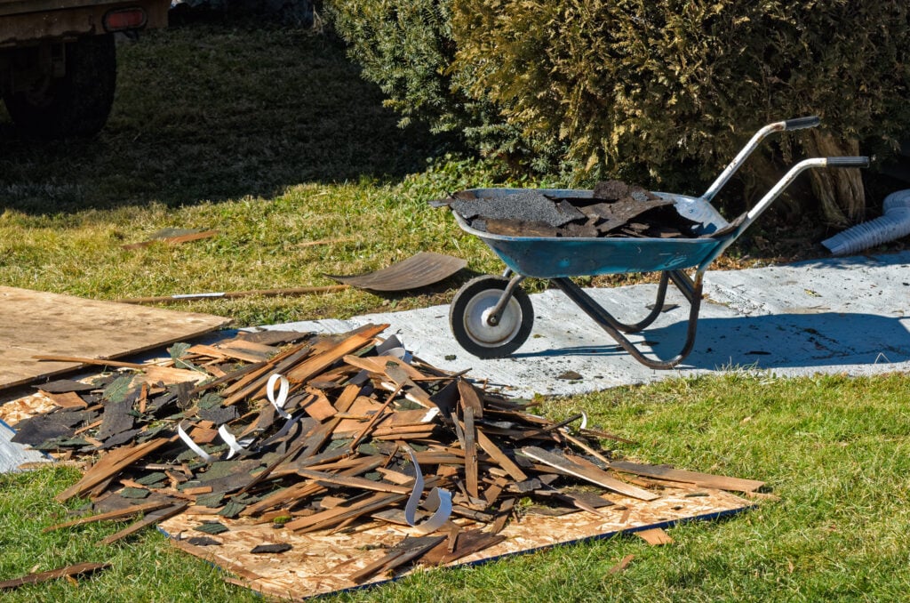 Pile of Torn Off Shingles and Boards From Old Roof