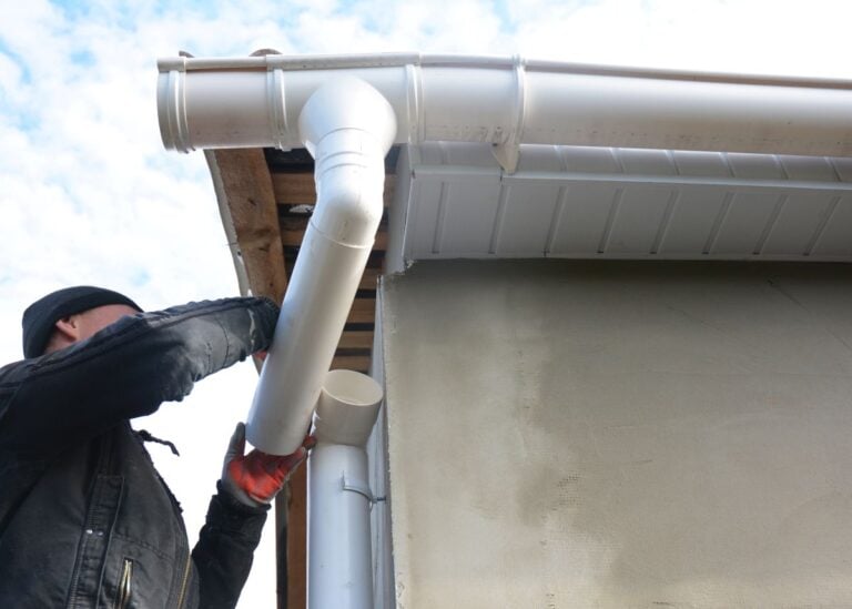 gutter downspout worker installing new gutter system