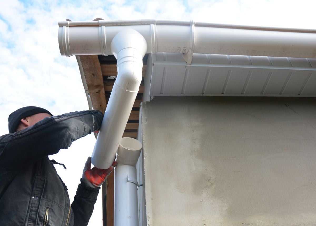gutter downspout worker installing new gutter system