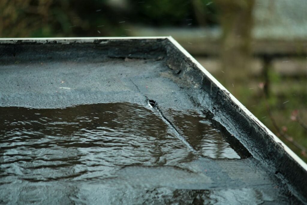 does homeowners insurance cover roof leaks black flat roof