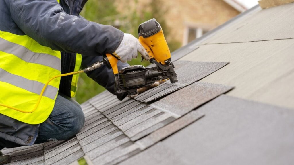 guy installing shingles roof