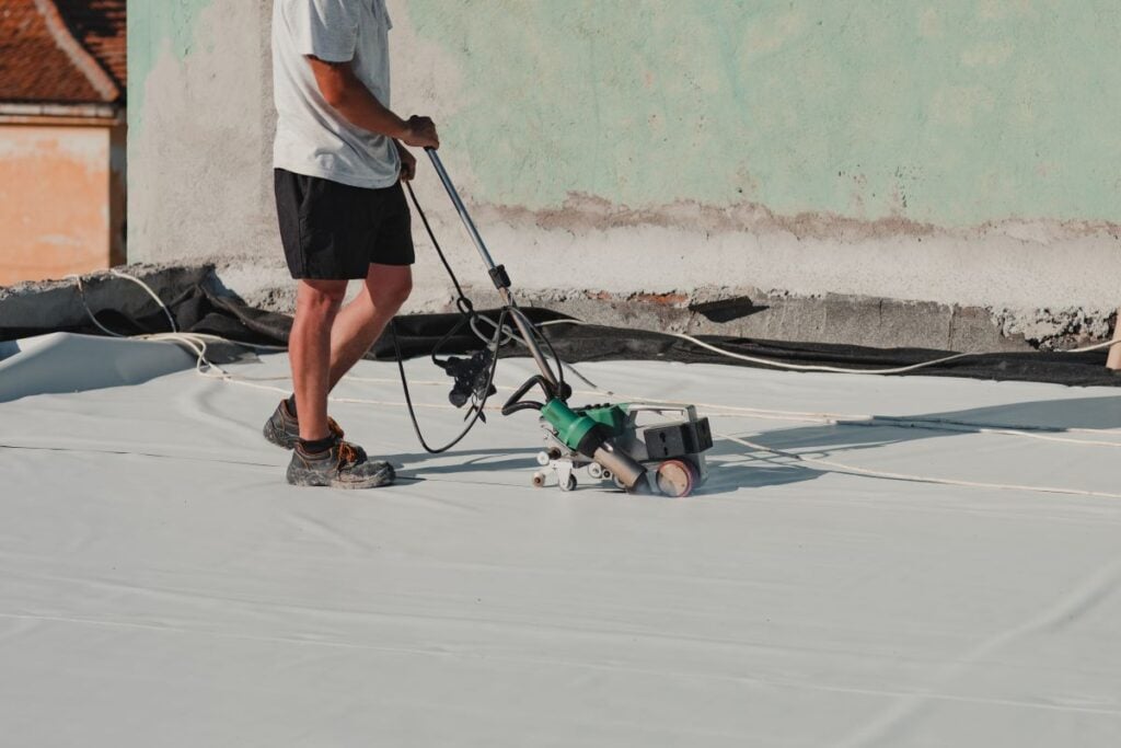 roof waterproofing services guy using heating machine